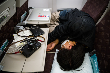 I lie down across the aisle on my flight to Seoul, which departed the Los Angeles International Airport Wednesday, Nov. 11, 2020. The flight only had about two dozen passengers who were scattered across the 396-seat airplane; due to the coronavirus pandem