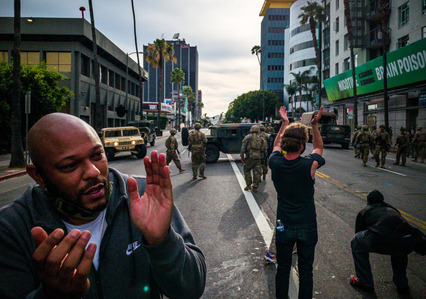 Protesters applaud the California Army National Guard after the guardsmen took over from the Los Angeles Police Department in diffusing tension with the protesters in Hollywood Tuesday, June 2, 2020.