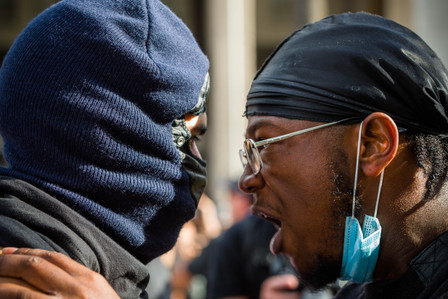 A protest leader who identified himself as "X," right, tells his fellow protester Tuesday, June 2, 2020, that they should stay nonviolent, avoid arrest and save the energy for more protests to come in the following days.