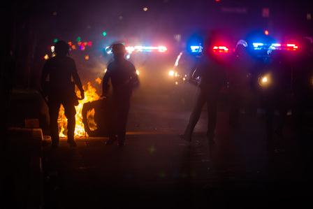 A column of LAPD officers approach a trash fire on Melrose Avenue. LA Mayor Eric Garcetti enforced a countywide 8 p.m. curfew in response to the violent protests, but the looting continued well into the night.