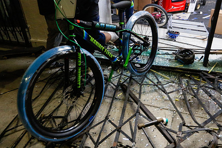 A looter steals a bicycle from Spokes 'N Stuff, a local bicycle shop chain in Los Angeles.