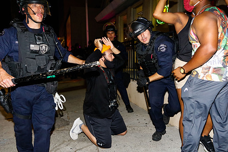 ​Los Angeles police officers on Sunset Boulevard beat unarmed protesters with batons Monday, June 1, 2020.