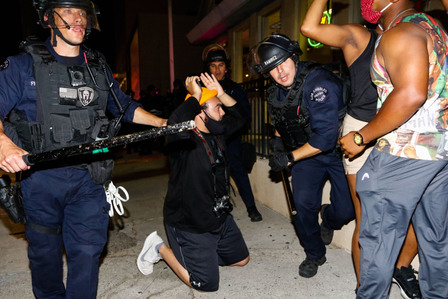 ​Los Angeles police officers on Sunset Boulevard beat unarmed protesters with batons Monday, June 1, 2020.