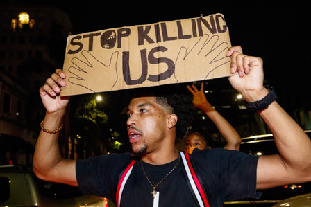 A man protests peacefully on Sunset Boulevard on the night of Monday, June 1, 2020 breaking a countywide curfew. LAPD later fired rubber bullets at the group of protesters that he was with.
