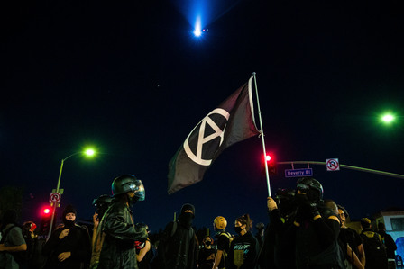 About 200 protesters, many of them in black bloc gear, march around central Los Angeles, Sunday, Aug. 30, 2020 for a three-month commemoration of the Fairfax protest.