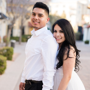 Bride nuzzles groom from behind while posing at the Villages in Lake Las Vegas