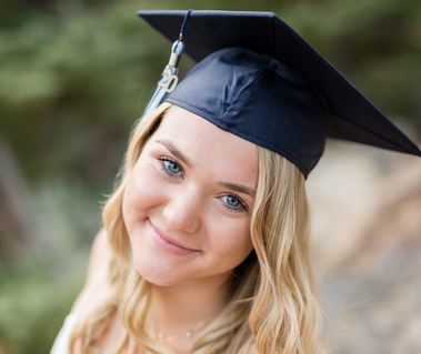 Blonde high school senior girl wearing a navy cap for her Las Vegas senior portraits