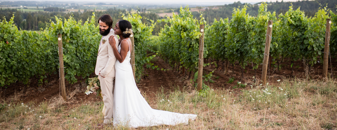 Bride and Groom in a vineyard at Domaine Roy in Dundee, Oregon
