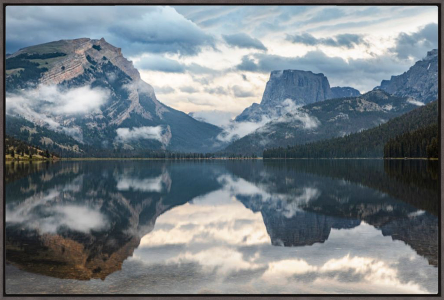 Morning sunrise with clouds reflecting in the calm water at Squaretop Mountain in the Wind River Range of Wyoming