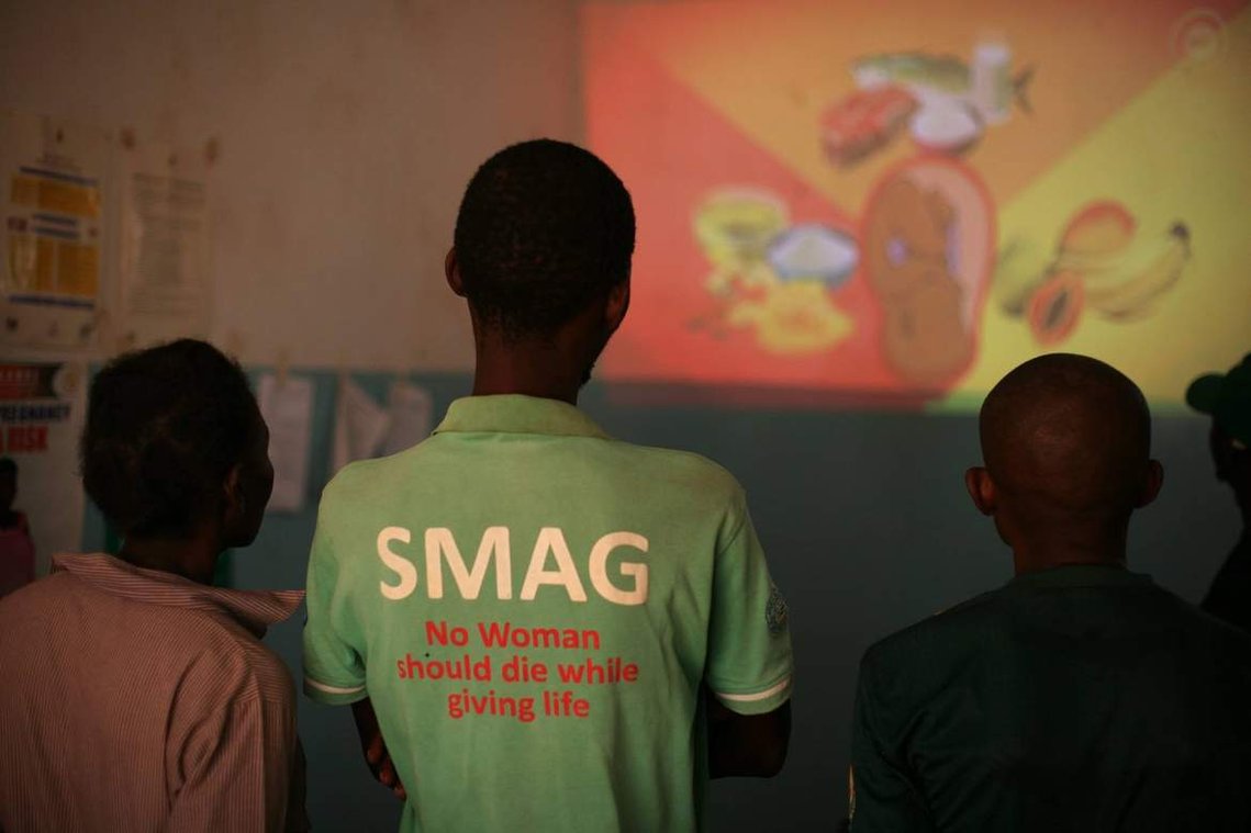 Image: Community health workers watch an educational film at Kabundi health clinic in the Serenje District of Zambia
