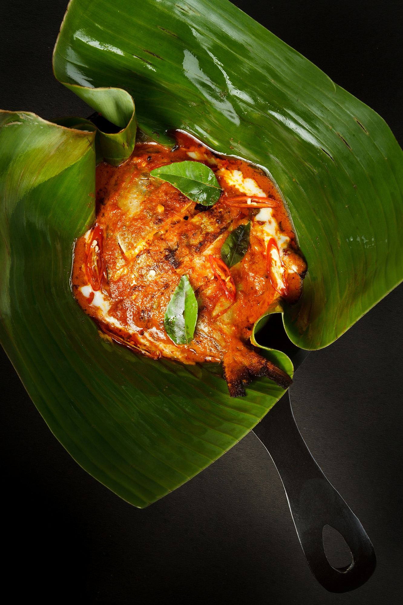 Kerala-style Fish Nirvana served in a pan at The Studs, Uttarakhand
