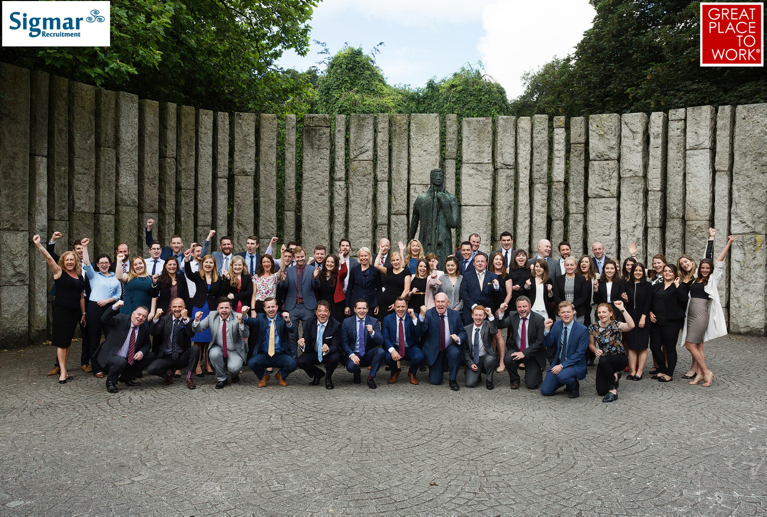 Large corporate company group photo outdoors winning great place to work award