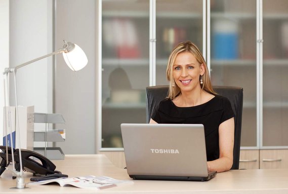 Corporate profile portrait. Businesswoman in office environment professional portrait for website 