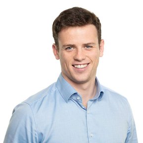 Professional business Headshot of  young male in blue shirt white background