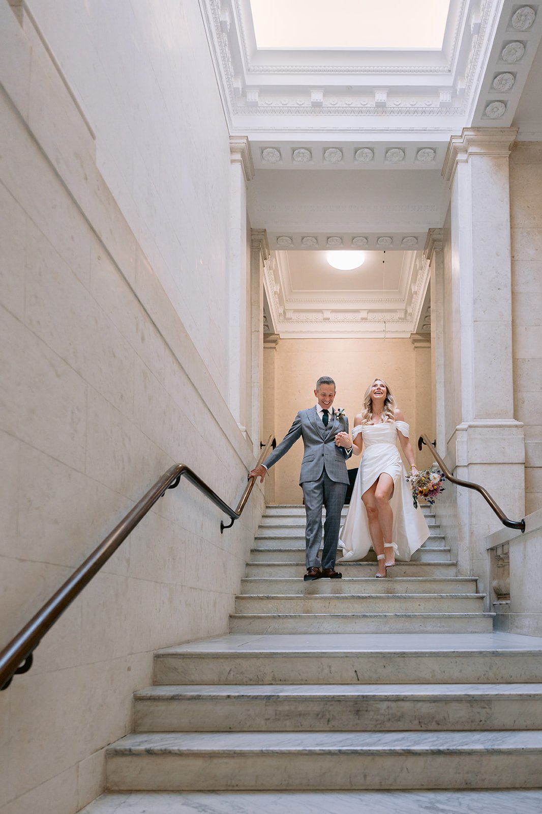The Old Marylebone Town Hall Wedding Ruth Buscombe and Nathan Divey Walking Down Steps