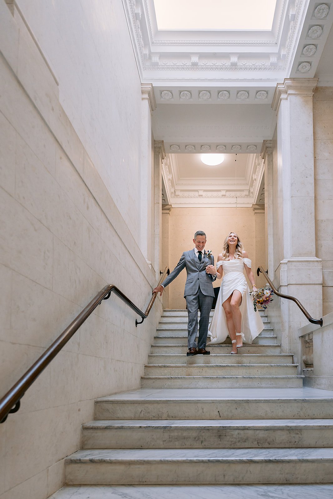 The Old Marylebone Town Hall Wedding Ruth Buscombe and Nathan Divey Walking Down Steps