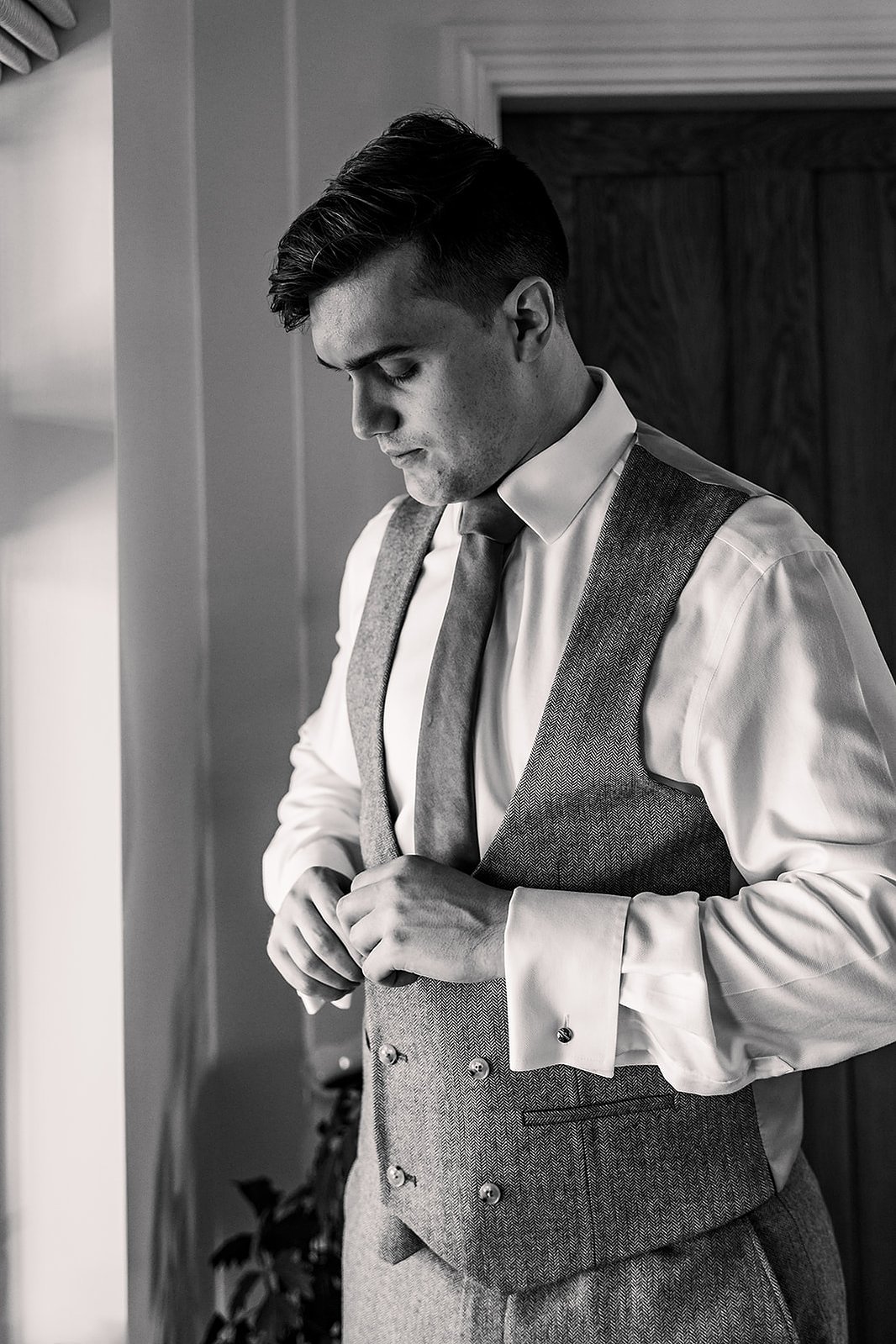 Guildford Manor Hotel & Spa Wedding Groom Doing Up Waistcoat
