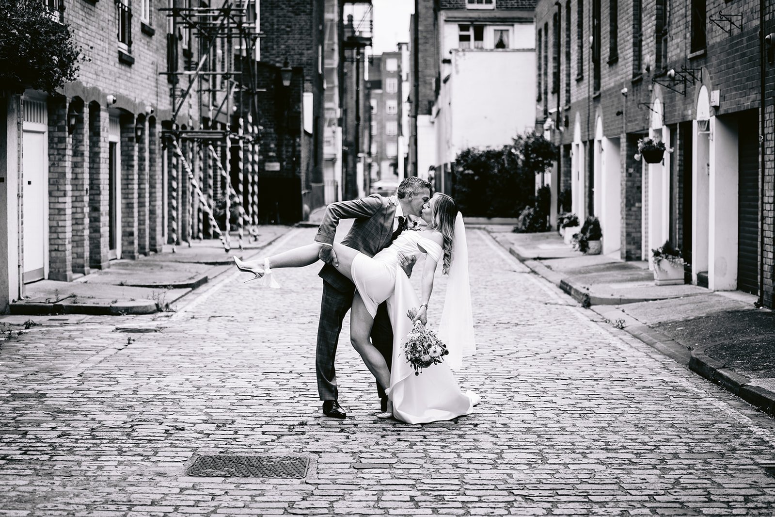 The Old Marylebone Town Hall Wedding Ruth Buscombe and Nathan Divey Dip Kiss in Salisbury Place