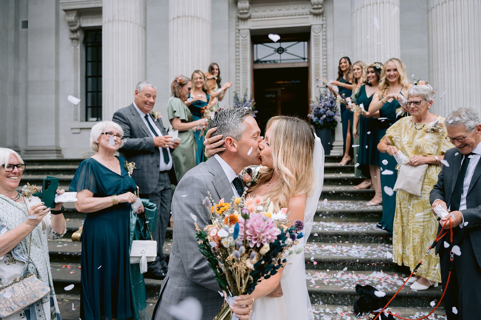 The Old Marylebone Town Hall Wedding Ruth Buscombe and Nathan Divey Kissing on Steps