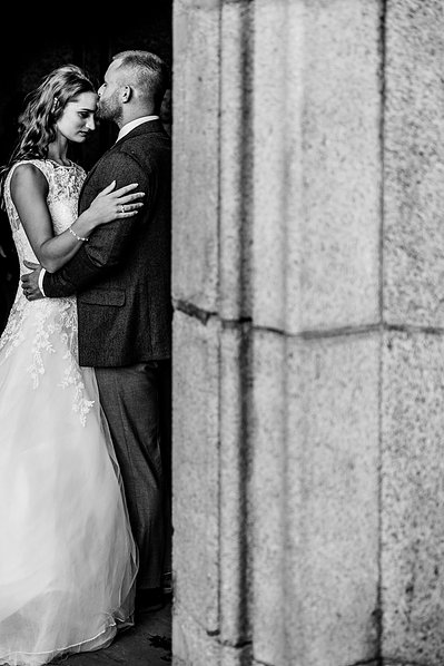 Bride and Groom against pillers