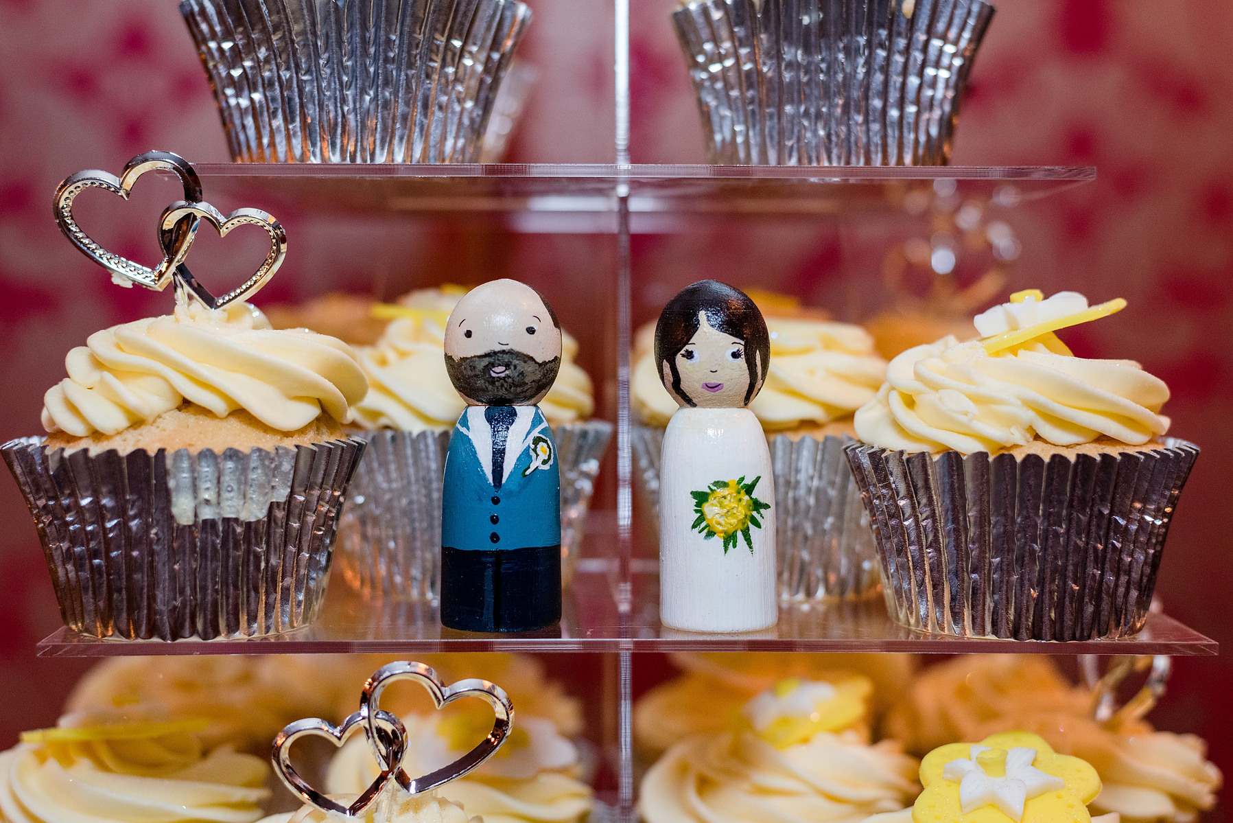 Miniature bride and groom next to cupcakes taken at William Cecil Hotel