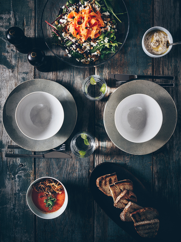 Dark rustic table setup with modern Middle Eastern food 