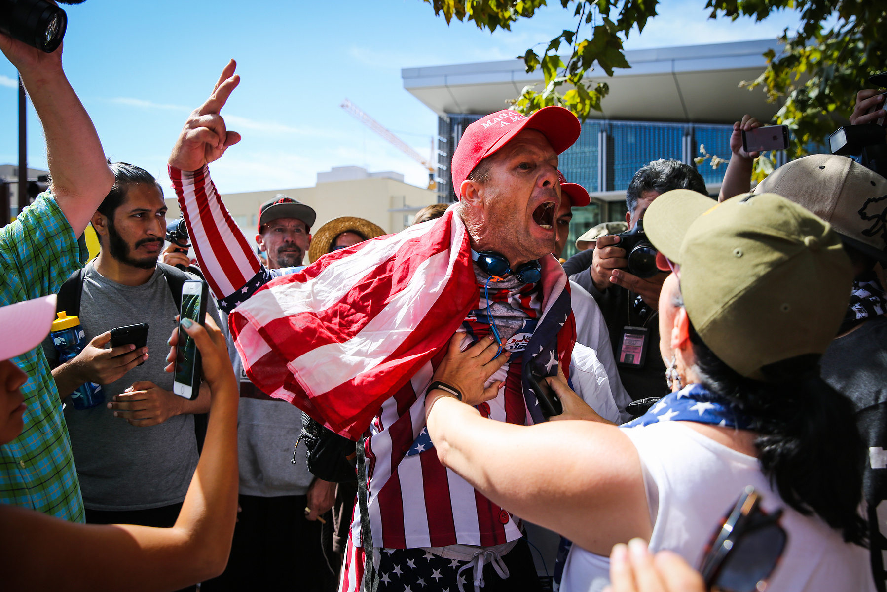 People hold back Trump supporter John Turano (center) while he argeud with another Trump supporter after Milo Yiannopolous spoke to a small crowd at UC Berkelely in Berkeley, Calif., on Sunday, Sept. 24, 2017.