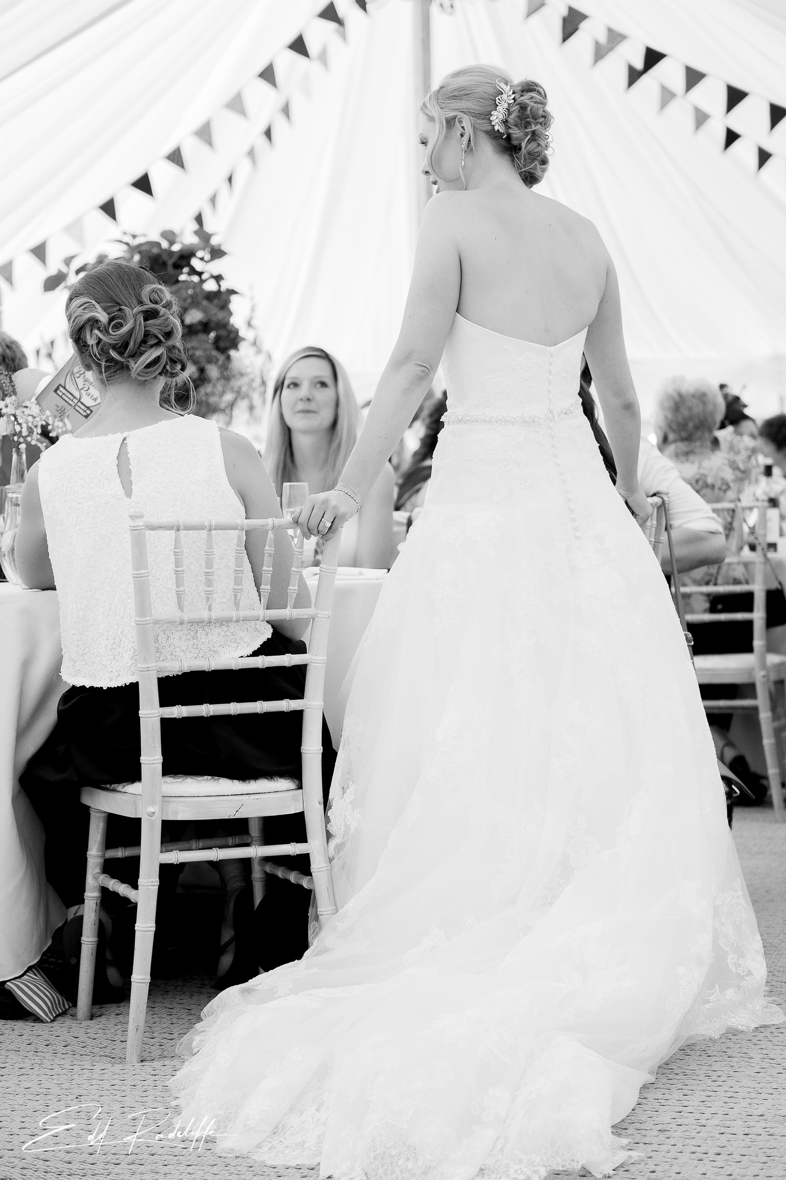 View of the Bride as she chats to guest at the wedding breakfast at Porthmawr Country House in Crickhowell, Wales for Edd Radcliffe Photography - documentary style wedding photography