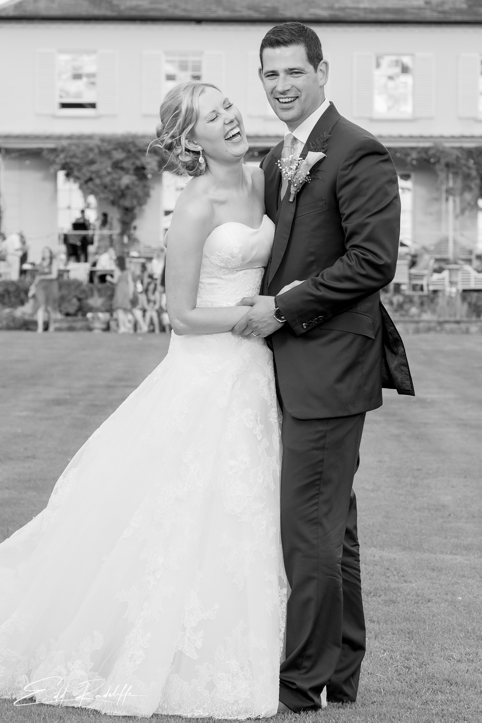 Bride and Groom stand together holding hands at wedding reception  at Porthmawr Country House in Crickhowell, Wales for Edd Radcliffe Photography - documentary style wedding photography