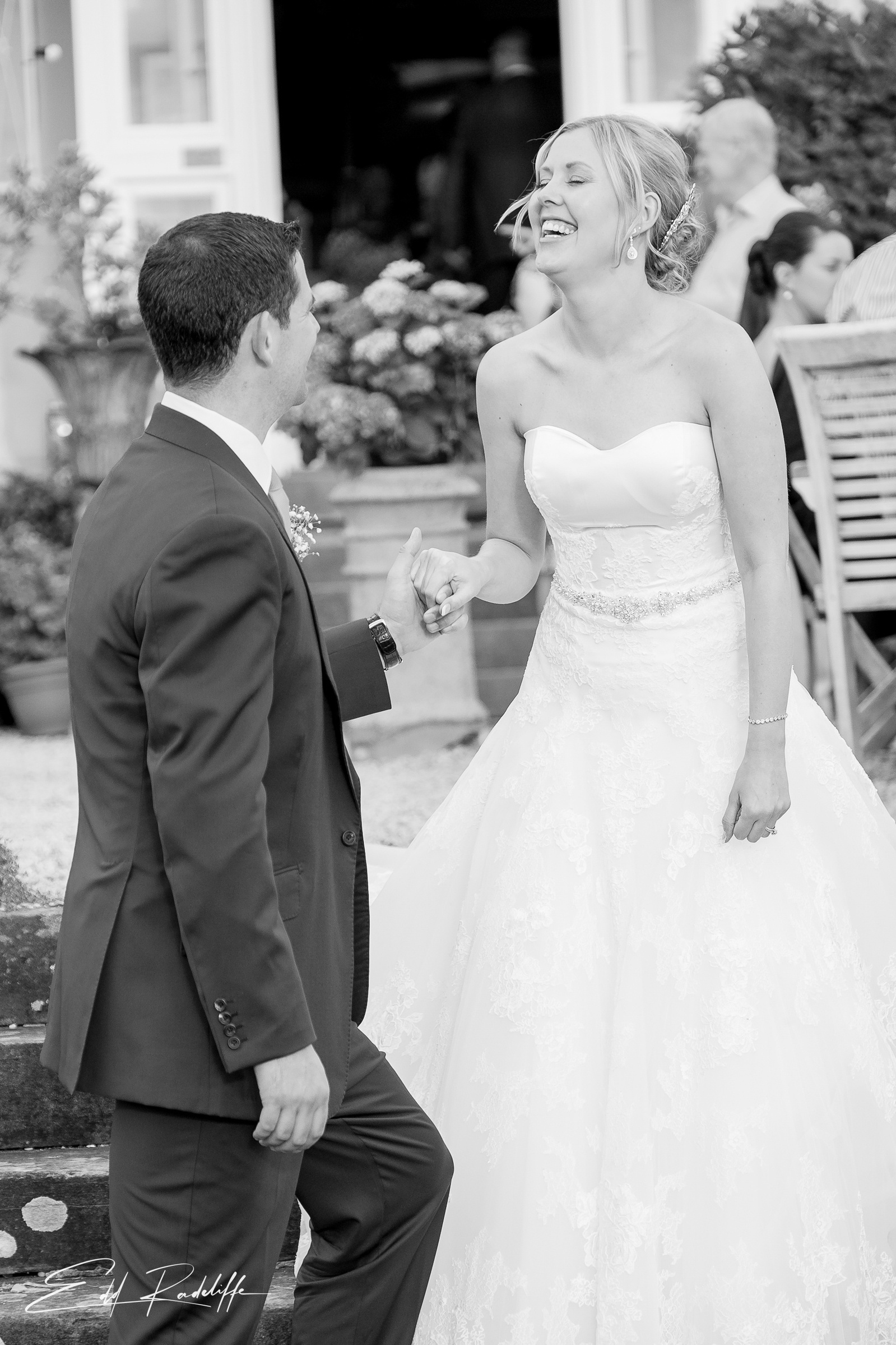 Bride laughs as Groom takes her hand at Porthmawr Country House in Crickhowell, Wales for Edd Radcliffe Photography - documentary style wedding photography