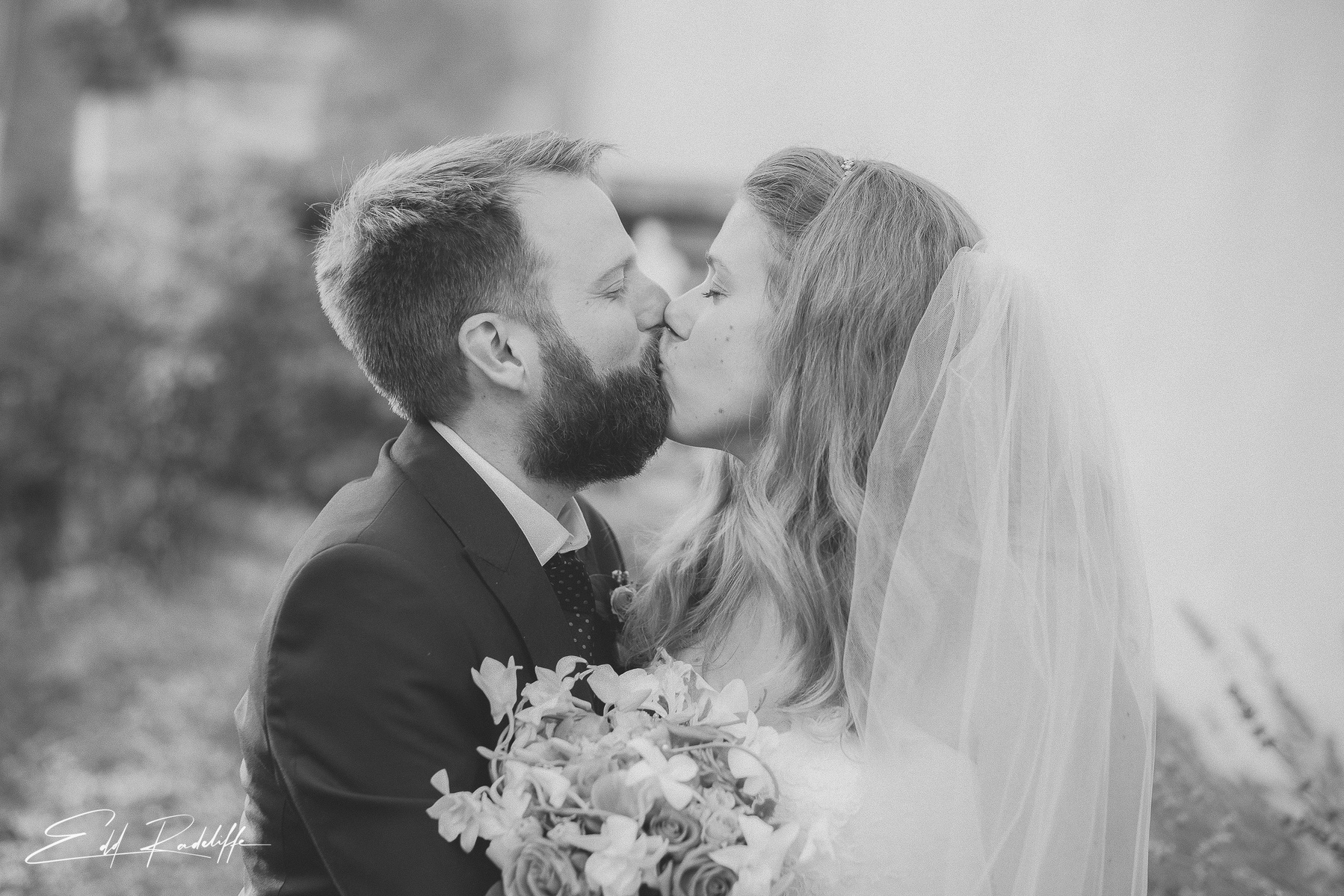Bride and Groom kiss while Bride holds wedding bouquet at Hôtel de Cours de Thomazeau in Castilliones for Edd Radcliffe Photography - documentary style wedding photography