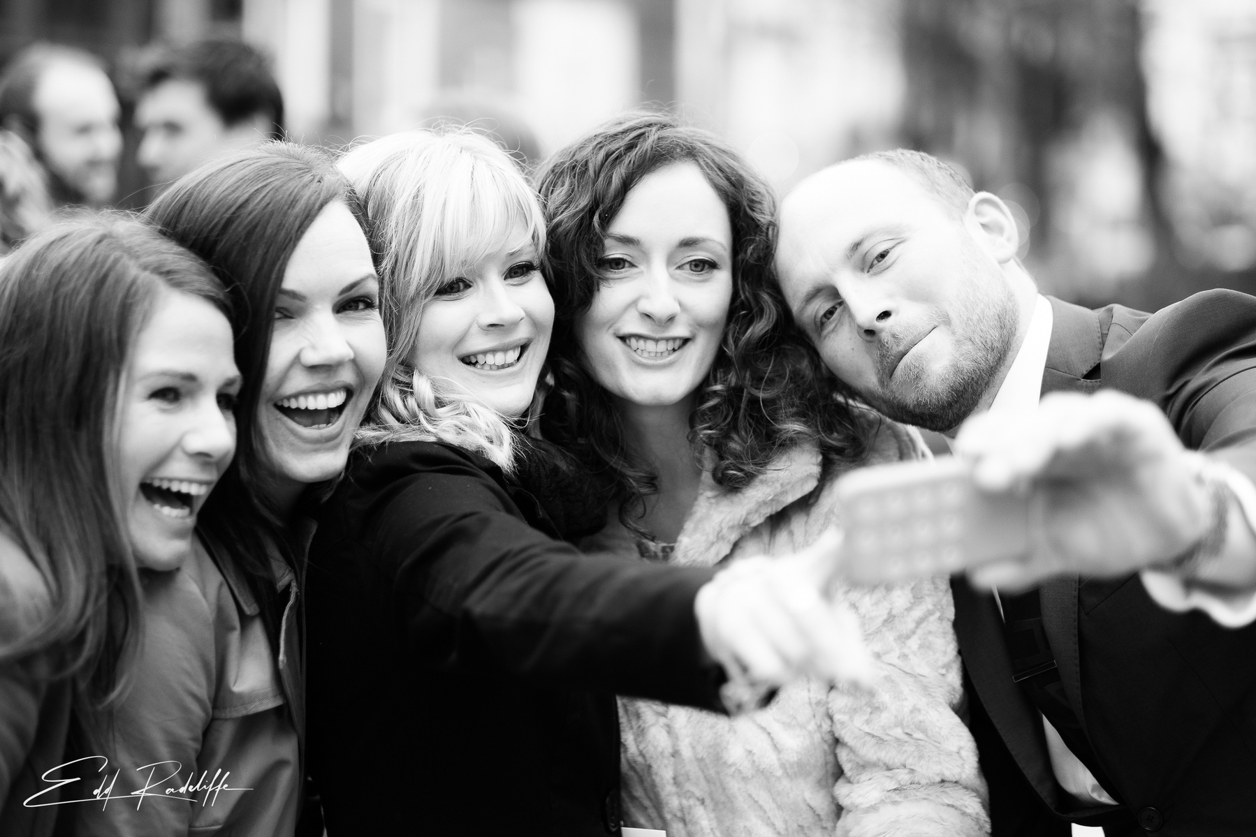 Friends pose for camera outside Islington Town Hall, London after wedding ceremony for Edd Radcliffe Photography - documentary style wedding photography