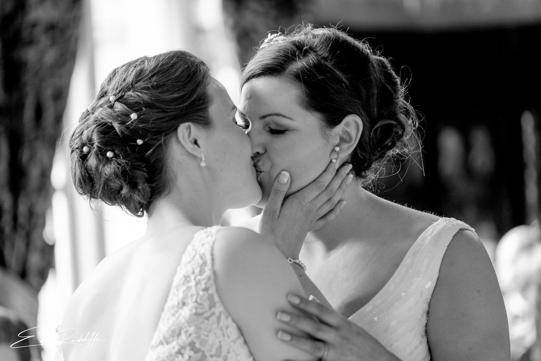 Brides share a kiss after wedding ceremony at Carlton Towers, Yorkshire for Edd Radcliffe Photography - documentary style wedding photography