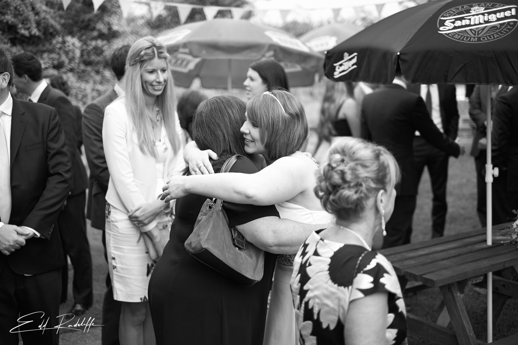 Bride hugs wedding guest at wedding reception at the Square and Compass in Somerset for Edd Radcliffe Photography - documentary style wedding photography