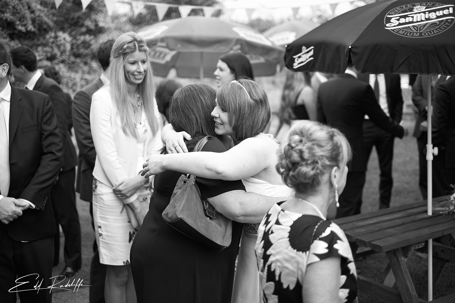 Bride hugs wedding guest at wedding reception at the Square and Compass in Somerset for Edd Radcliffe Photography - documentary style wedding photography