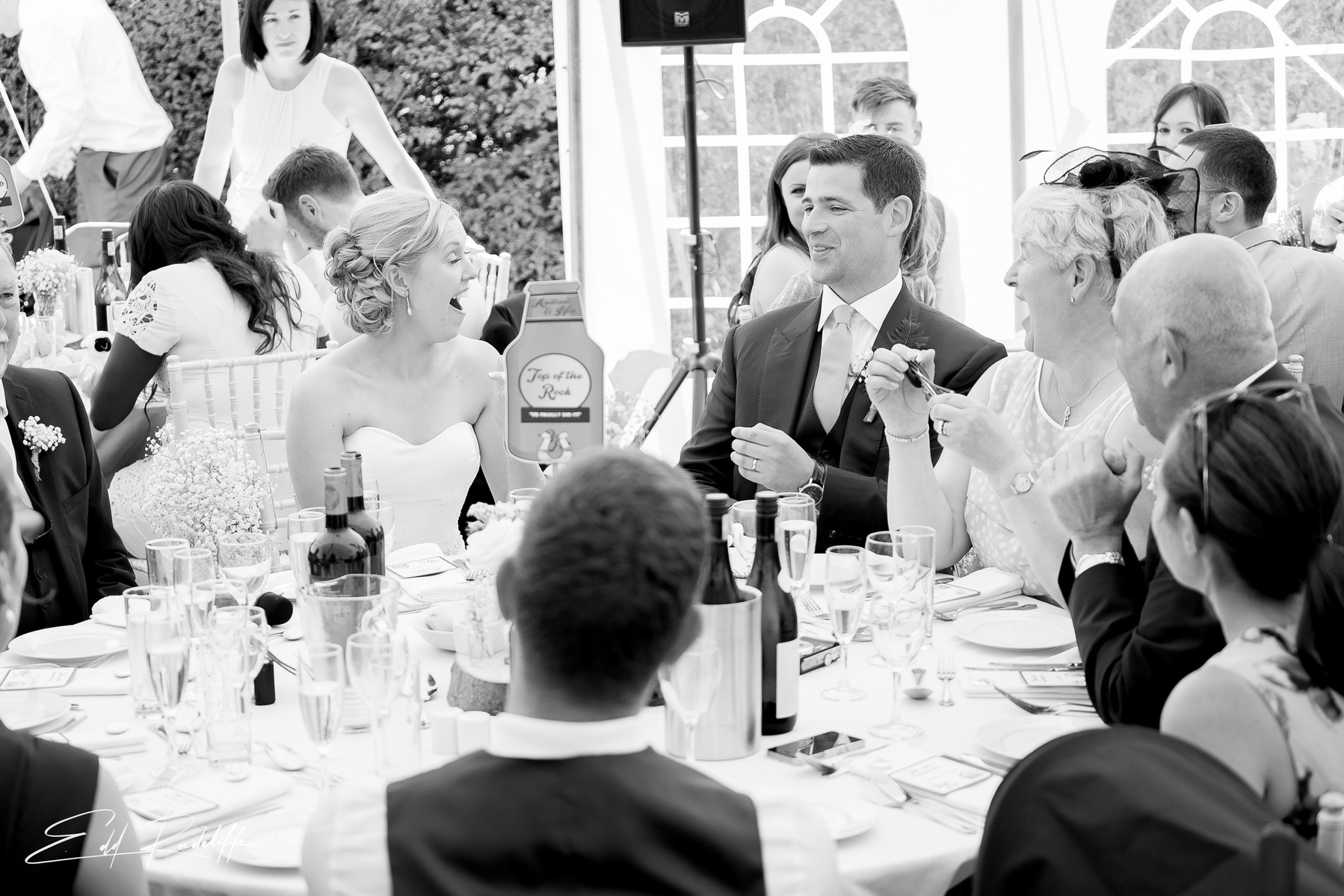 Bride and Groom laugh during the wedding speeches  at Porthmawr Country House in Crickhowell, Wales for Edd Radcliffe Photography - documentary style wedding photography