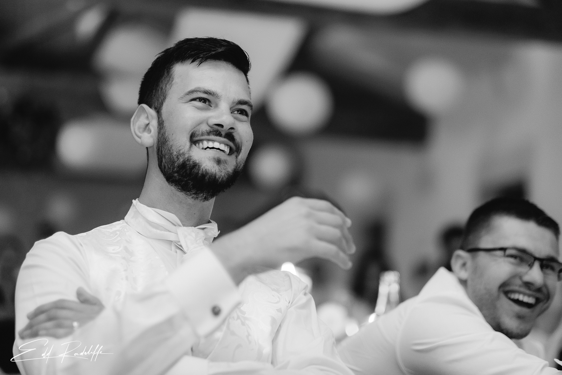 Groom looks on smiling at Garons, France for Edd Radcliffe Photography - documentary style wedding photography