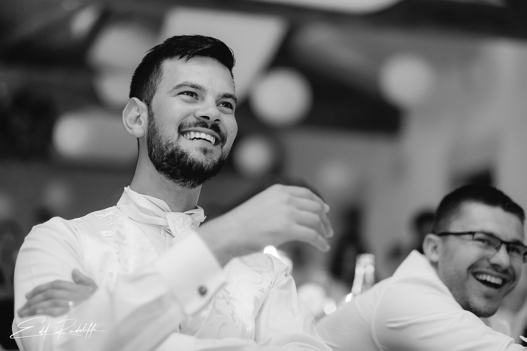 Groom looks on smiling at Garons, France for Edd Radcliffe Photography - documentary style wedding photography