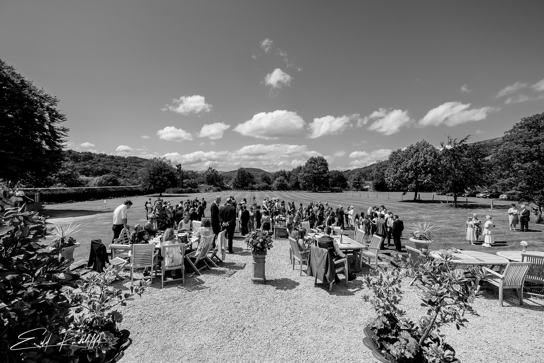 View of whole wedding congregation outside in grounds at Porthmawr Country House in Crickhowell, Wales for Edd Radcliffe Photography - documentary style wedding photography