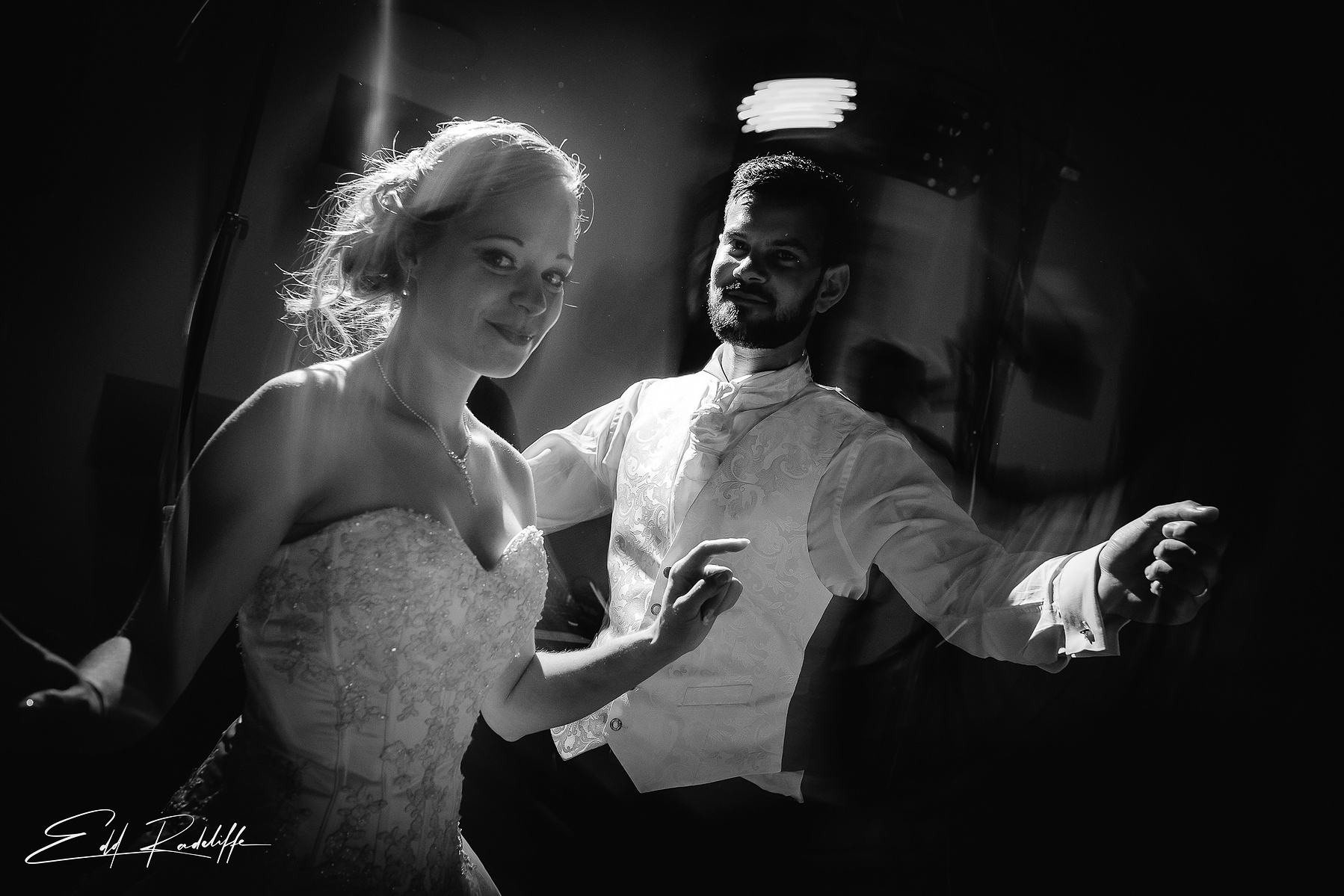 Bride and Groom twirl on dance floor at their wedding reception at Garons, France for Edd Radcliffe Photography - documentary style wedding photography