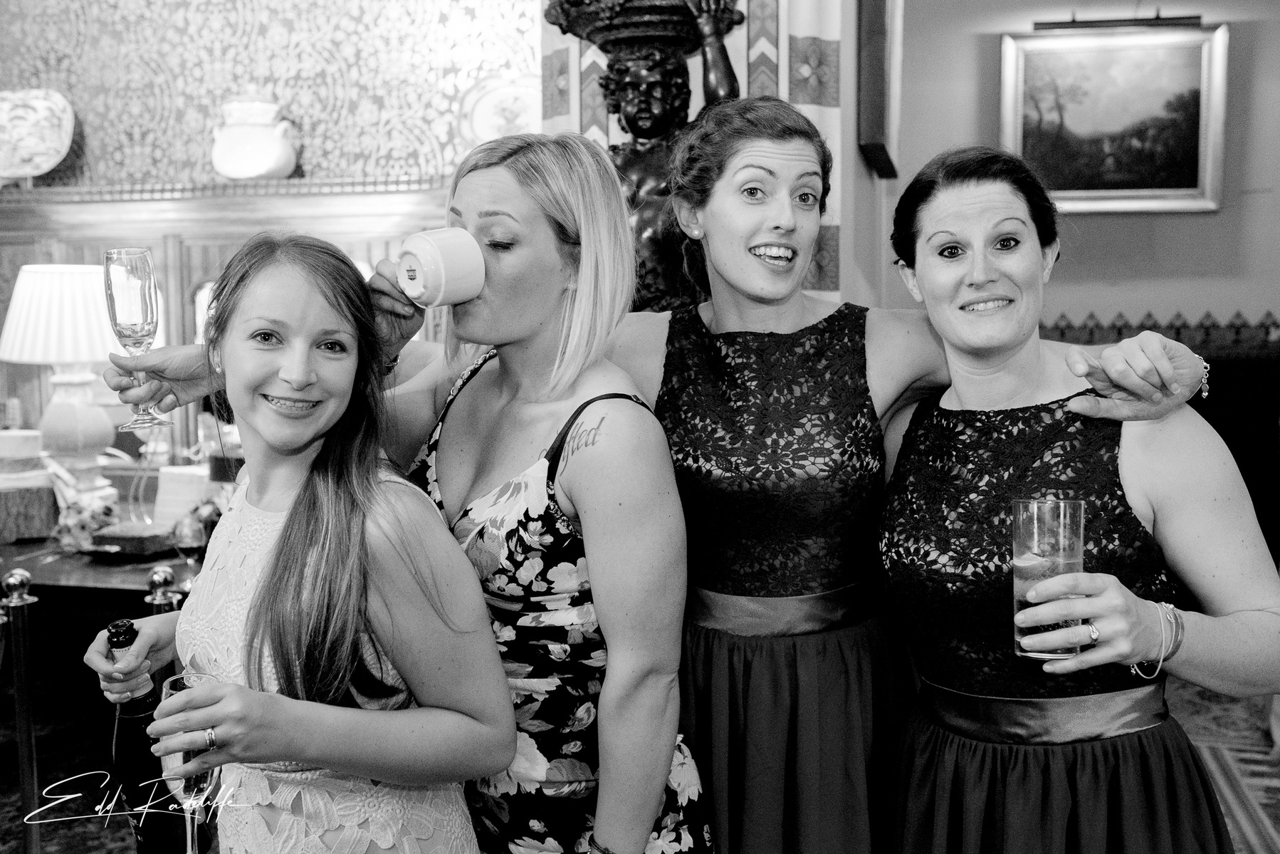 Wedding guest and Bridesmaids stand with arms around each other at Carlton Towers, Yorkshire for Edd Radcliffe Photography - documentary style wedding photography