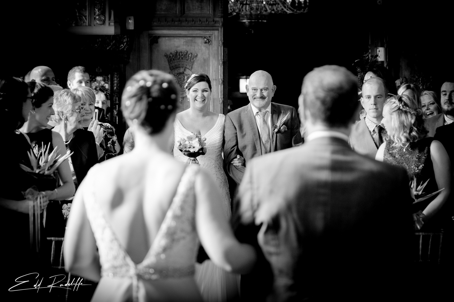 Brides walk towards each other down the aisle at Carlton Towers, Yorkshire for Edd Radcliffe Photography - documentary style wedding photography