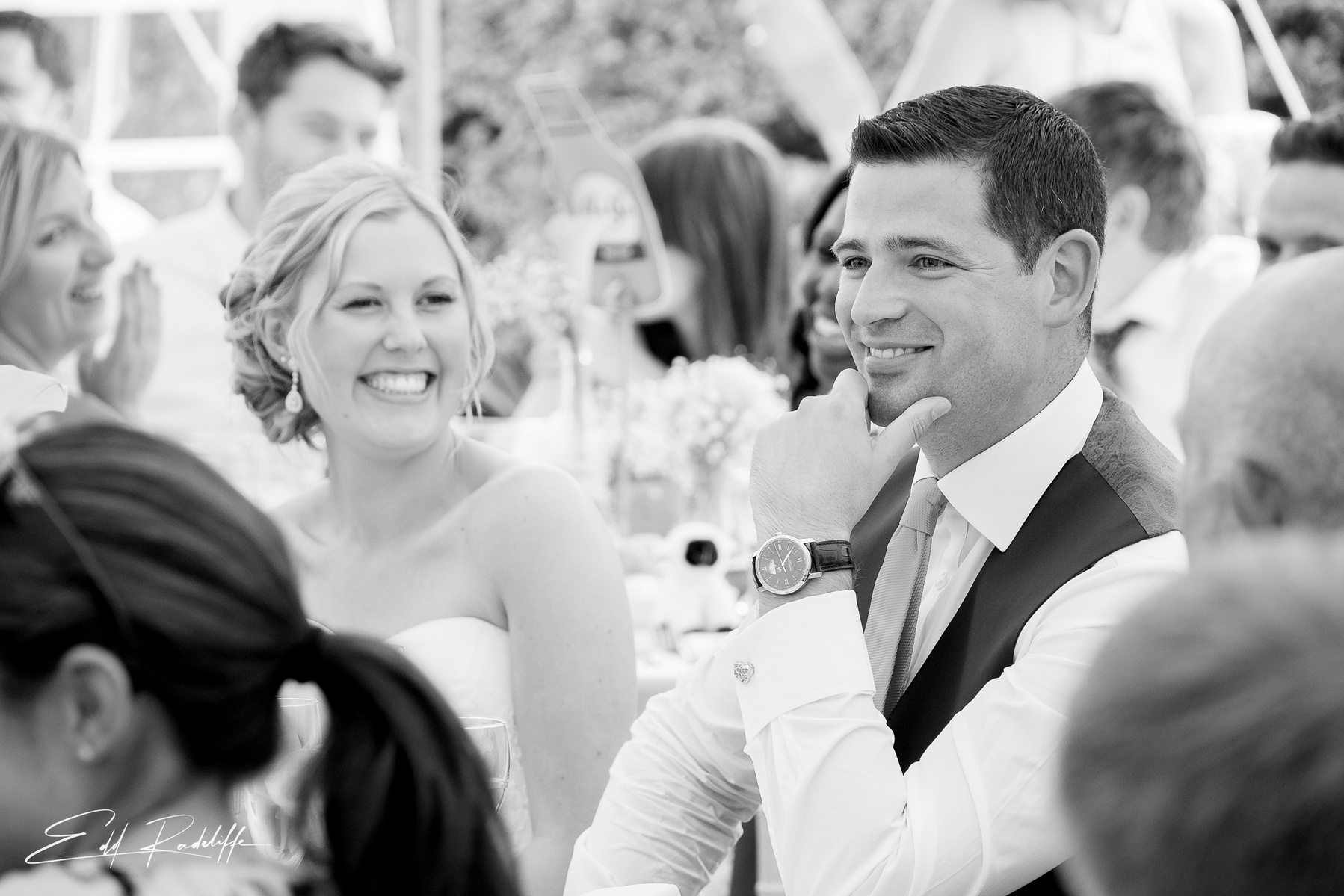 Bride and Groom smile while listening to speeches at Porthmawr Country House in Crickhowell, Wales for Edd Radcliffe Photography - documentary style wedding photography