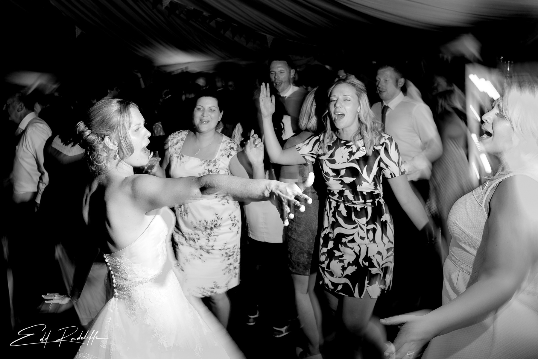 Bride sings and reaches out to friend on dance floor  at Porthmawr Country House in Crickhowell, Wales for Edd Radcliffe Photography - documentary style wedding photography