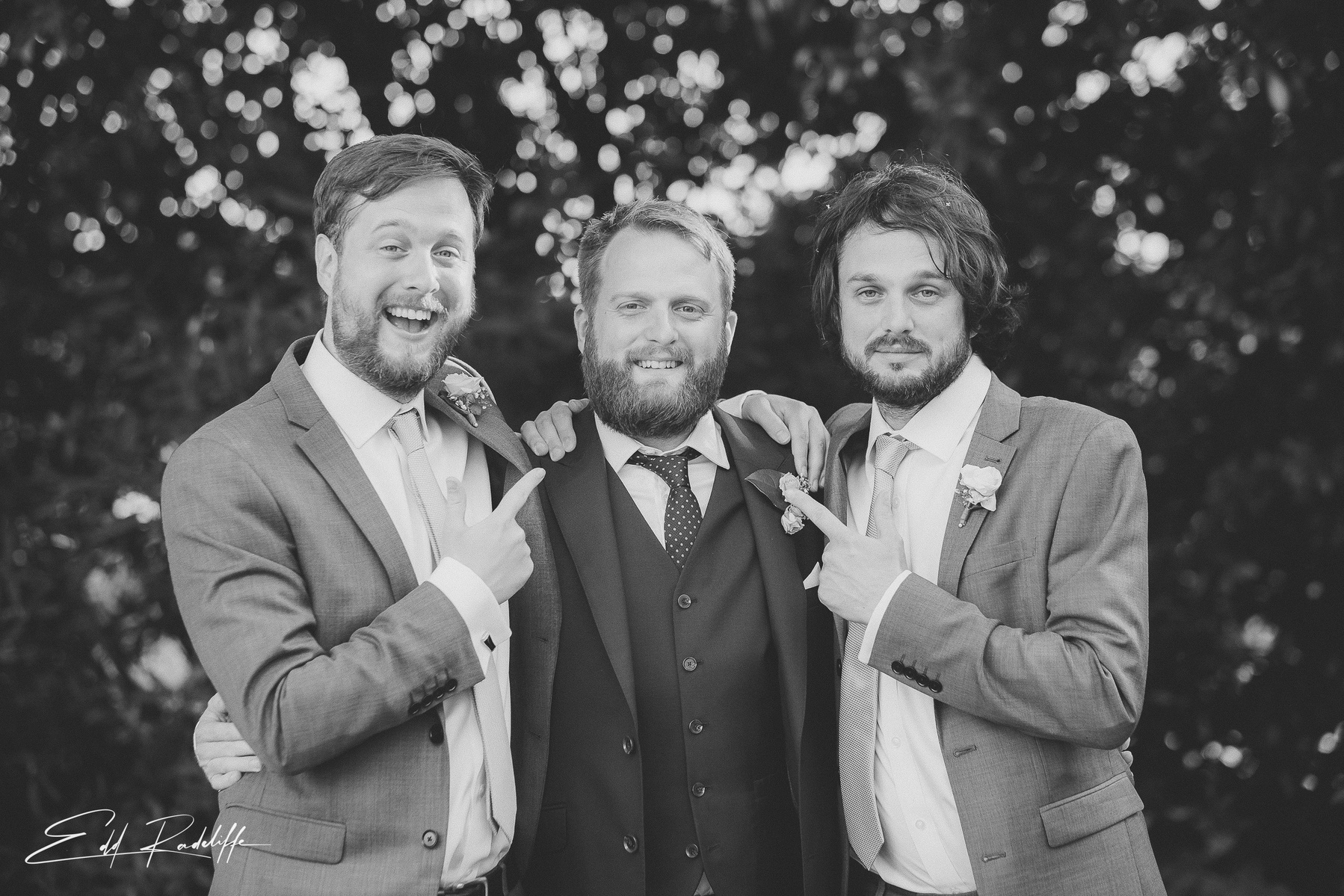 Groom embraces Groomsmen as they point at him at Hôtel de Cours de Thomazeau in Castilliones for Edd Radcliffe Photography - documentary style wedding photography