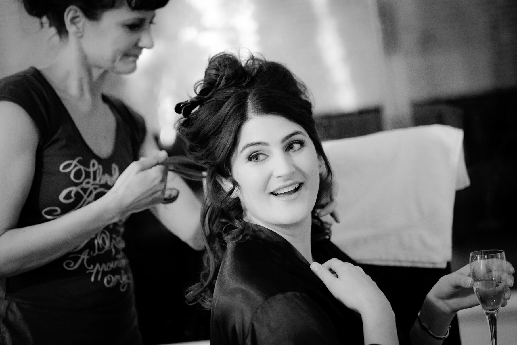 Bride having hair hair done while relaxing with champagne at Chiswell Street Dining Rooms, Islington for Edd Radcliffe Photography - documentary style wedding photography