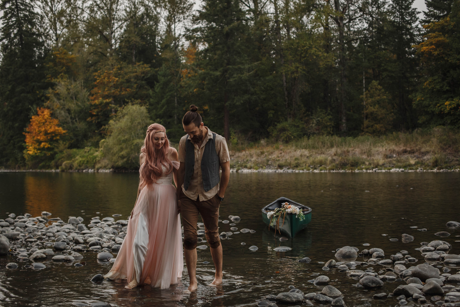 Bride and Groom hold hands and walk along the river near Portland, Oregon