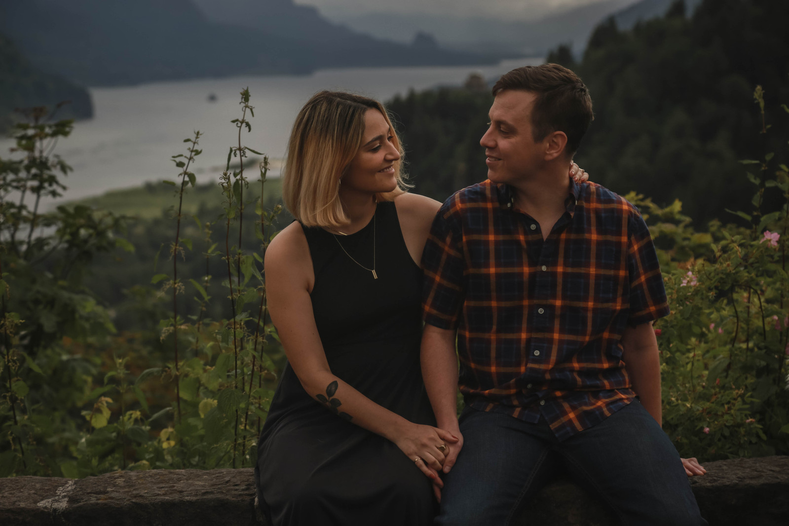 Couple Holding hands and smiling at each other in the Colombia River Gorge.