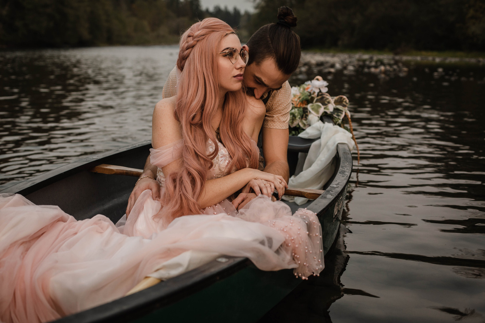 Couple in elopement attire float along a river in Oregon