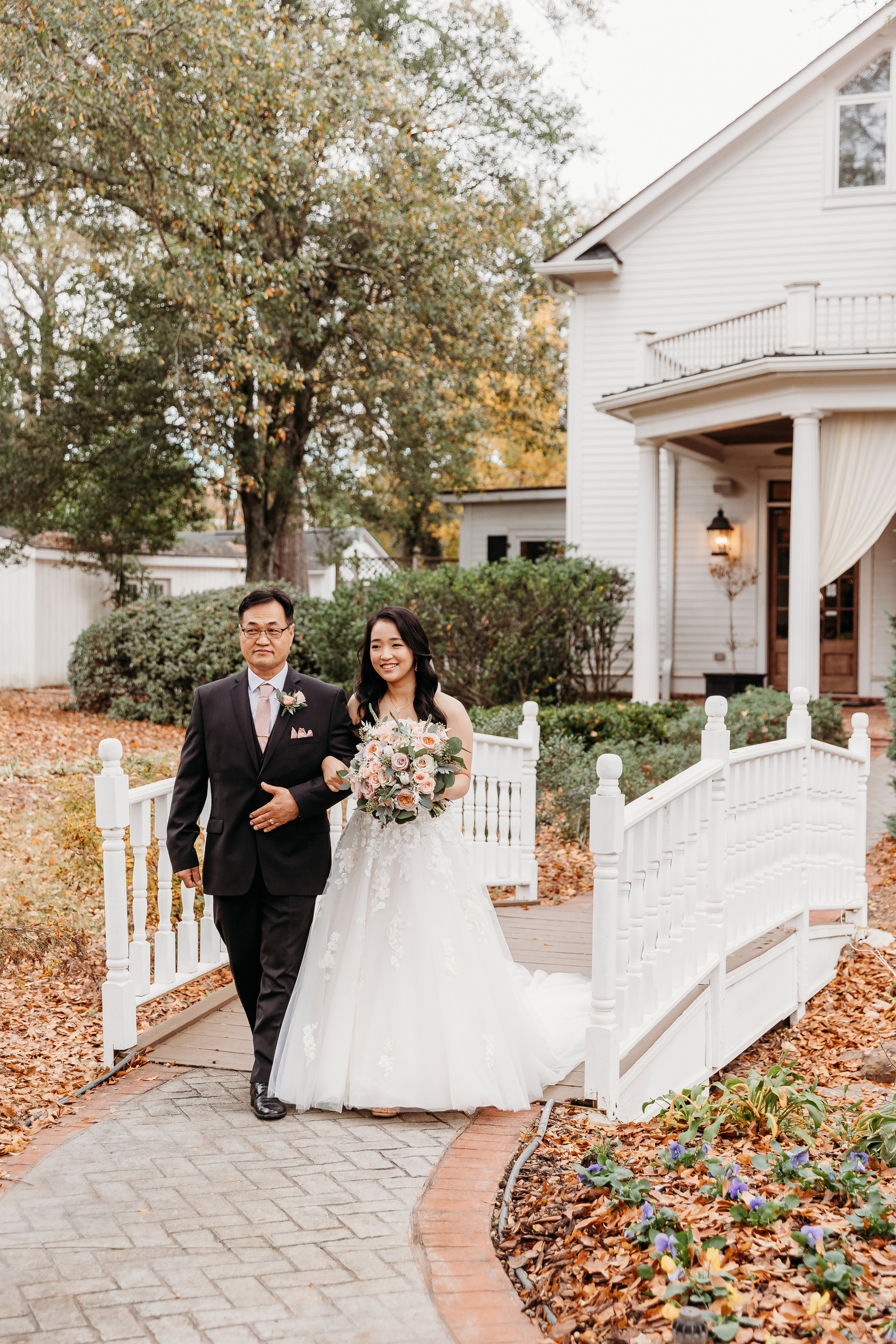 bride being escorted down the aisle by her dad